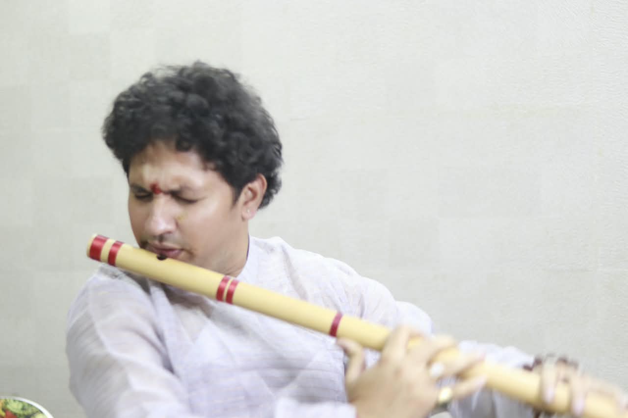 Acharya ji playing the bansuri